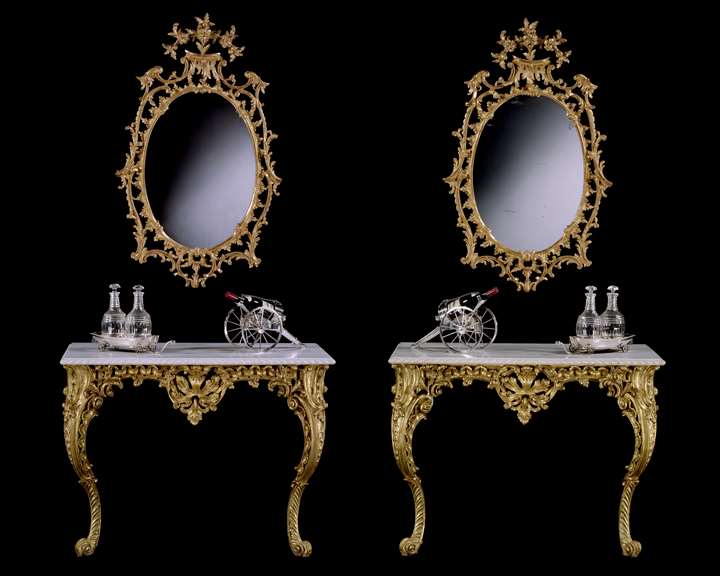 A PAIR OF GEORGE II CARVED GILTWOOD CONSOLE TABLES